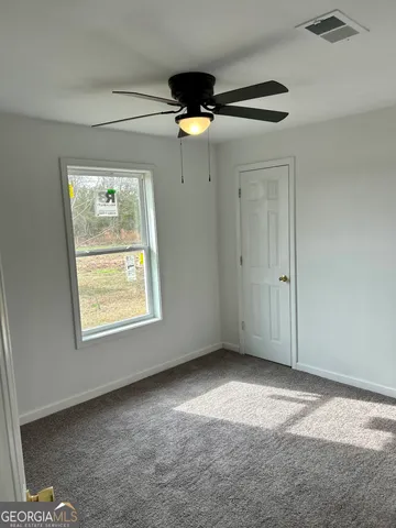 a view of kitchen with wooden floor and electronic appliances