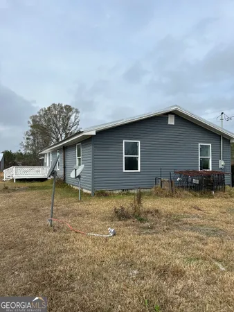 a view of house with backyard