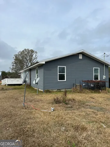 a view of house with backyard