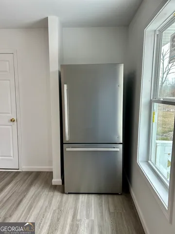 a view of wooden floor and windows in a room