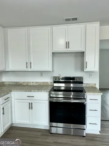 a stove top oven sitting inside of a kitchen