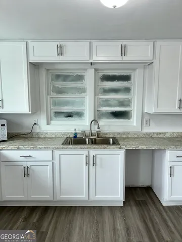 a kitchen with stainless steel appliances granite countertop a sink and dishwasher a stove with wooden floor