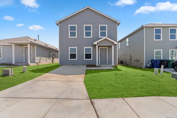 a front view of a house with a garden and yard