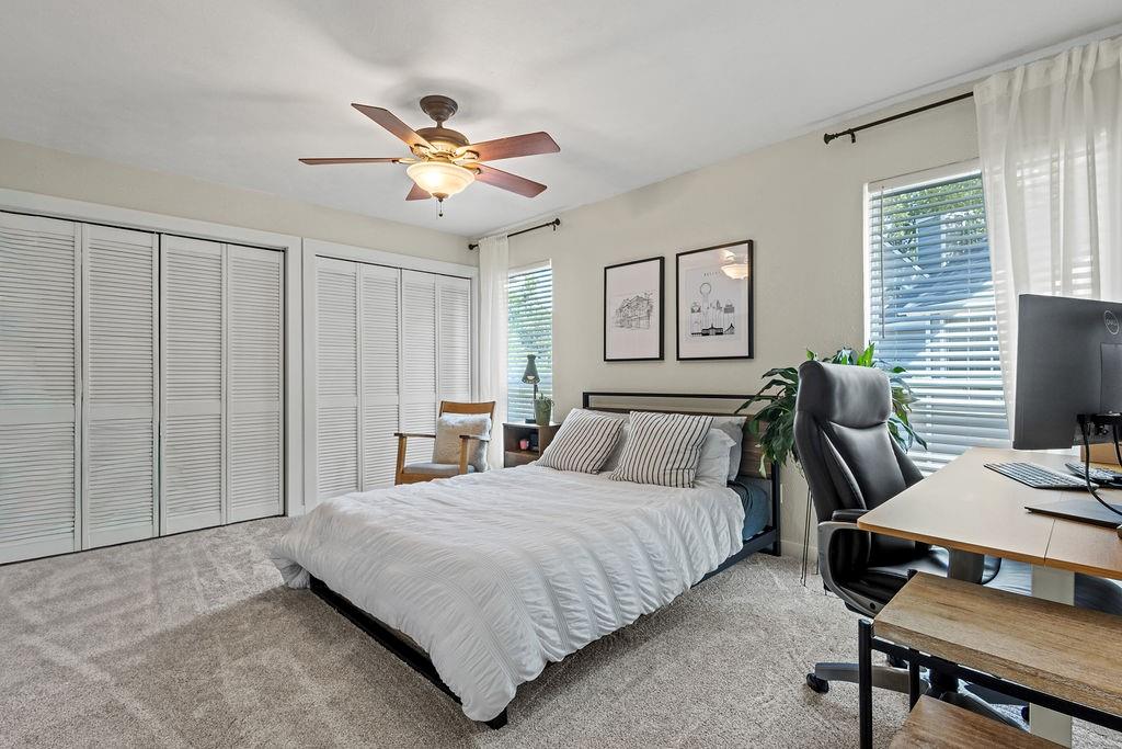 9222 Church Road, Unit 117 Dallas, TX 75231 - Photo 11 of 24 a bedroom with a bed and a chandelier