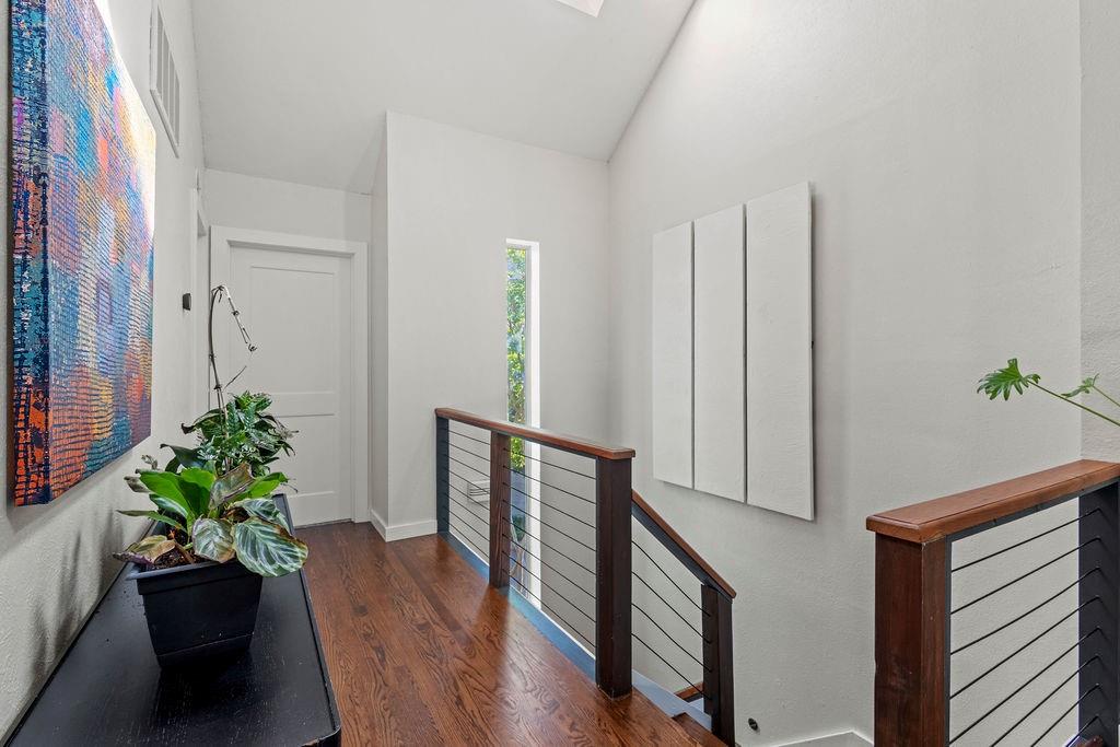 9222 Church Road, Unit 117 Dallas, TX 75231 - Photo 15 of 24 a hallway with wooden floor and a potted plant
