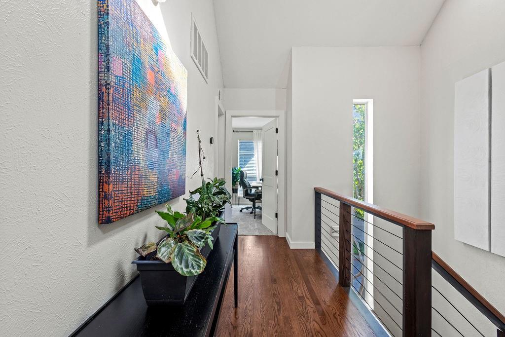 9222 Church Road, Unit 117 Dallas, TX 75231 - Photo 17 of 24 a view of a hallway with wooden floor and glass door