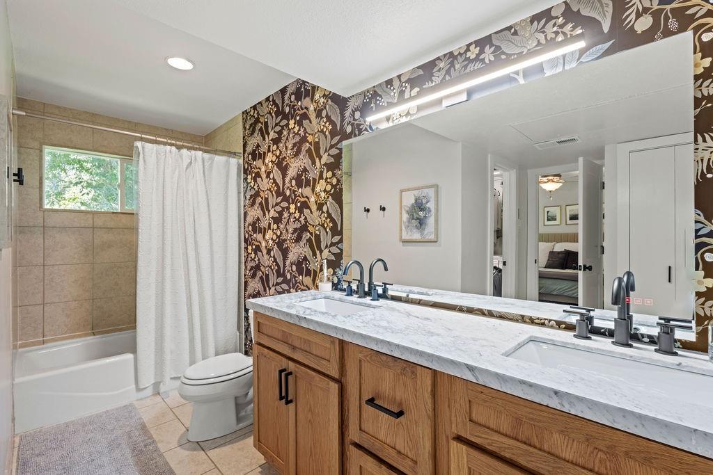 9222 Church Road, Unit 117 Dallas, TX 75231 - Photo 21 of 24 a bathroom with a double vanity sink toilet and shower