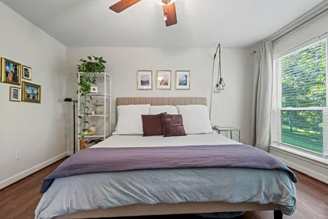 a bedroom with a large bed and a window