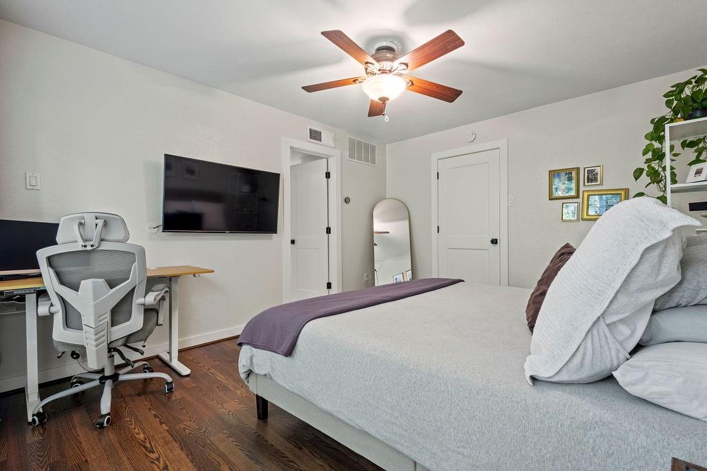 9222 Church Road, Unit 117 Dallas, TX 75231 - Photo 23 of 24 a bedroom with a bed a flat screen tv and a chandelier