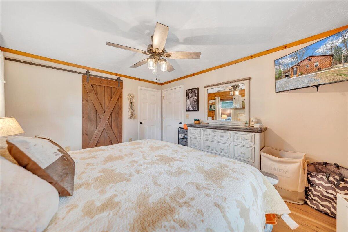 8013 Springwood Road Buchanan, VA 24066 - Photo 27 of 50 a bedroom with a bed and a chandelier