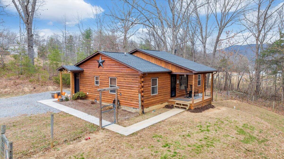 8013 Springwood Road Buchanan, VA 24066 - Photo 4 of 50 a view of a house with a yard and wooden fence