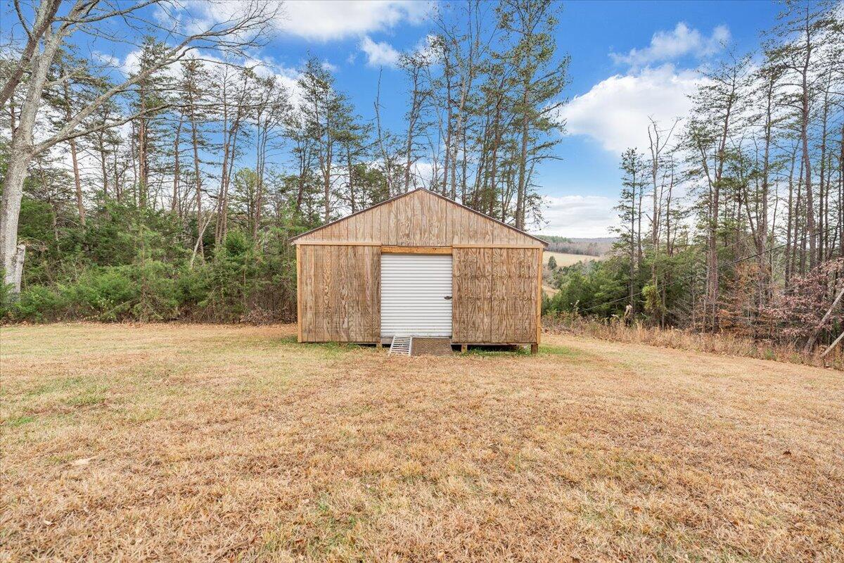 8013 Springwood Road Buchanan, VA 24066 - Photo 43 of 50 a backyard of a house with large trees and outdoor space