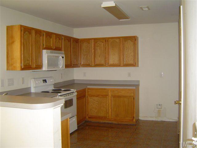 1204 Ricochet Drive Raleigh, NC 27610 - Photo 4 of 11 a kitchen with a sink and cabinets