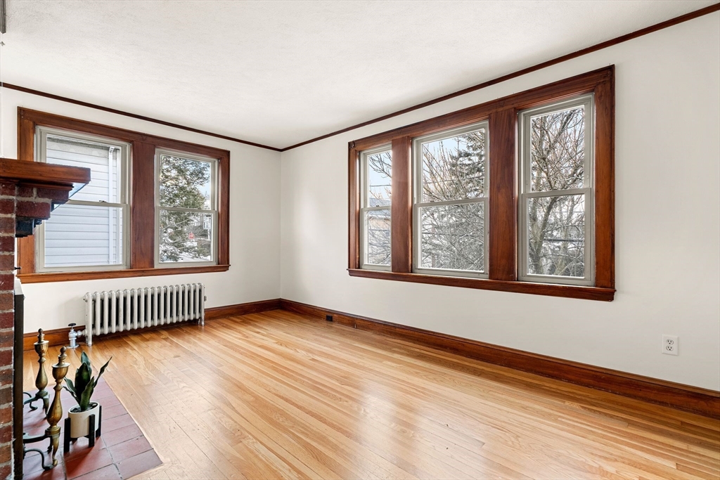 40-42 Upland Road Belmont, MA 02478 - Photo 15 of 35 a view of an empty room with wooden floor and fan
