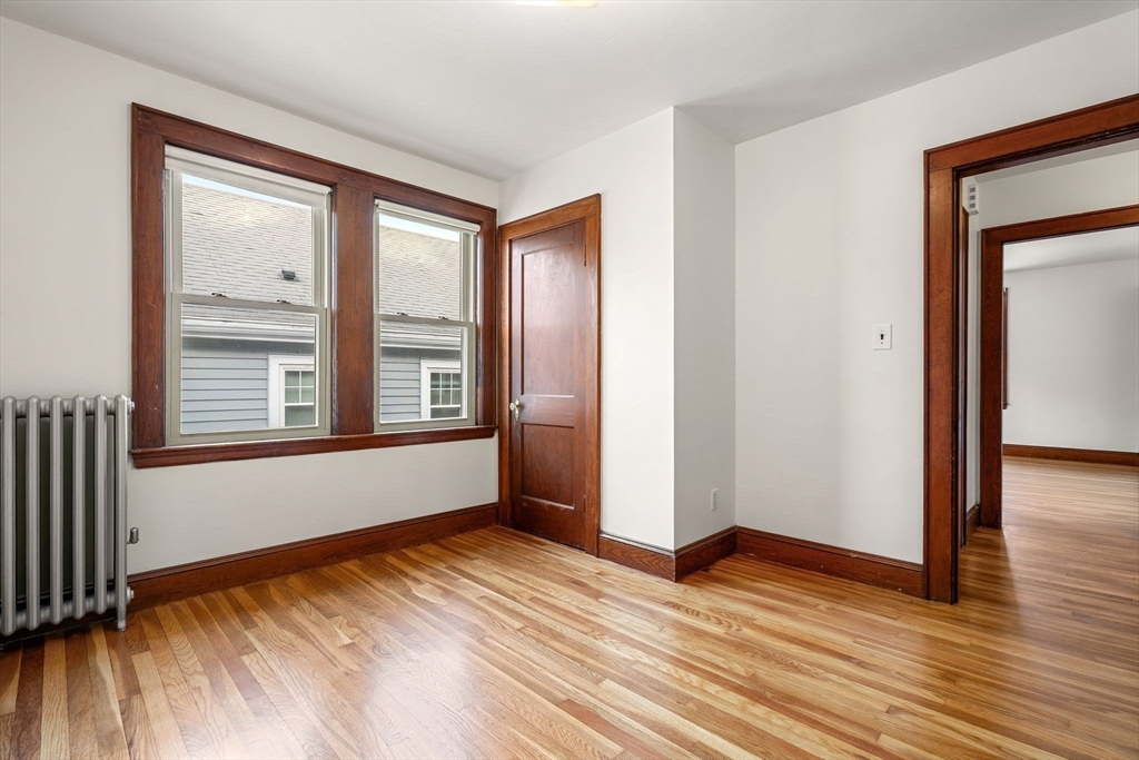 40-42 Upland Road Belmont, MA 02478 - Photo 19 of 35 a view of an empty room with wooden floor and a window