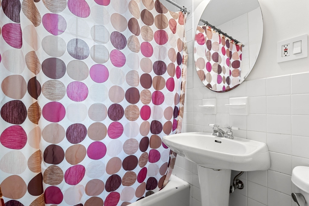 40-42 Upland Road Belmont, MA 02478 - Photo 25 of 35 a bathroom with a sink and mirror with painted walls