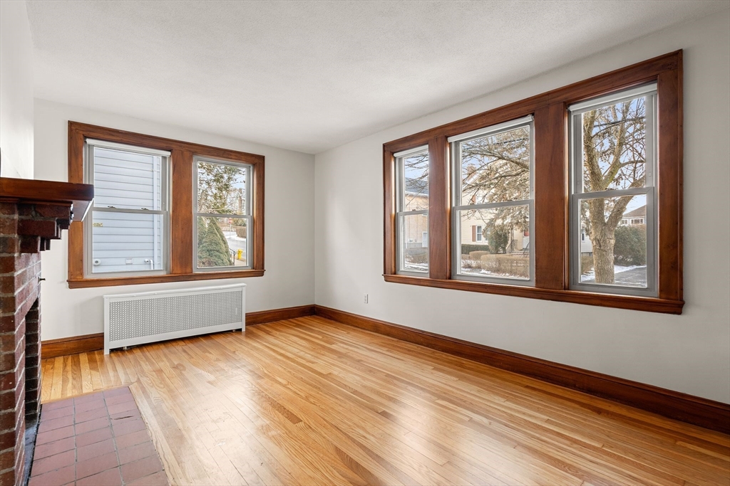 40-42 Upland Road Belmont, MA 02478 - Photo 3 of 35 a view of an empty room with wooden floor and a window