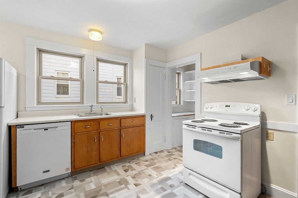 40-42 Upland Road Belmont, MA 02478 - Photo 5 of 35 a kitchen with cabinets a stove and a sink