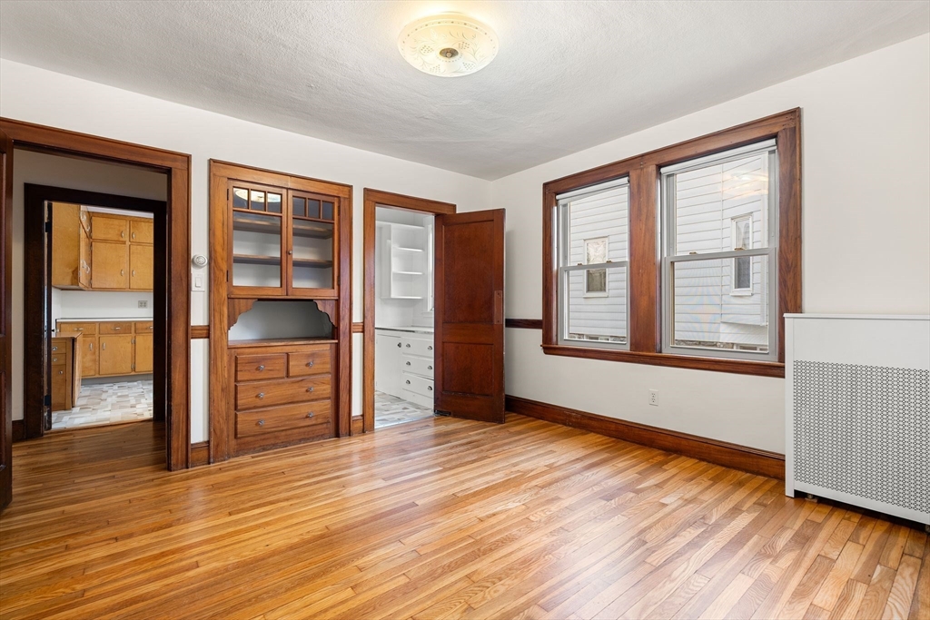 40-42 Upland Road Belmont, MA 02478 - Photo 9 of 35 a view of an empty room with window and wooden floor