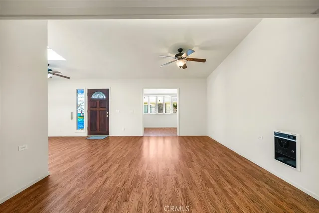 wooden floor in an empty room with a window
