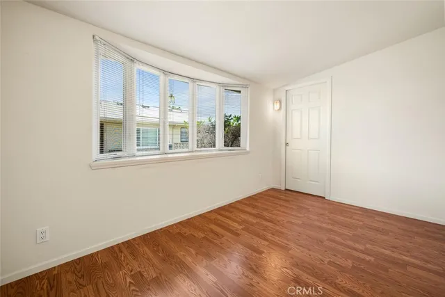 a view of a big room with wooden floor and closet