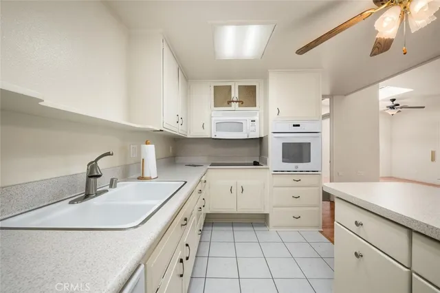 a kitchen with stainless steel appliances granite countertop a sink a stove and cabinets