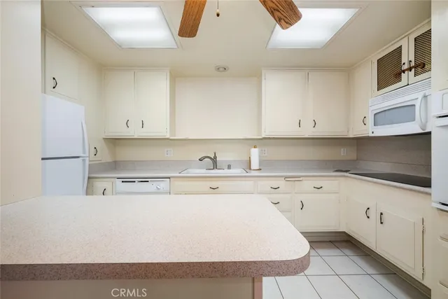 an empty room with closet and a chandelier fan