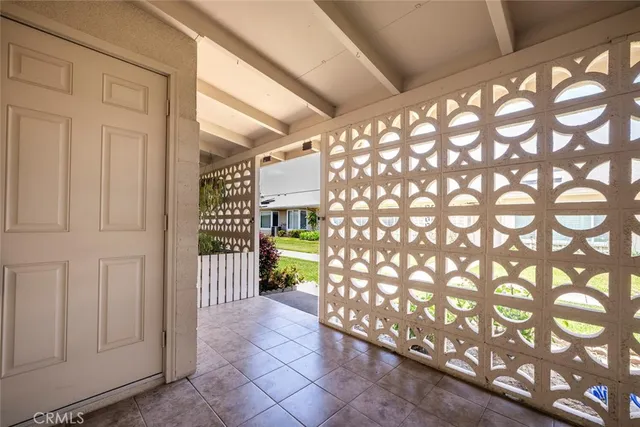 a view of an empty room with window and cabinet