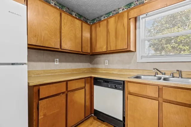 a white refrigerator freezer sitting in a kitchen