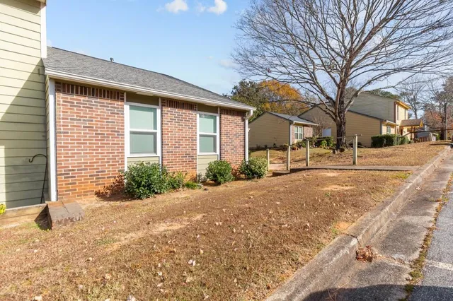 a front view of a house with a garden