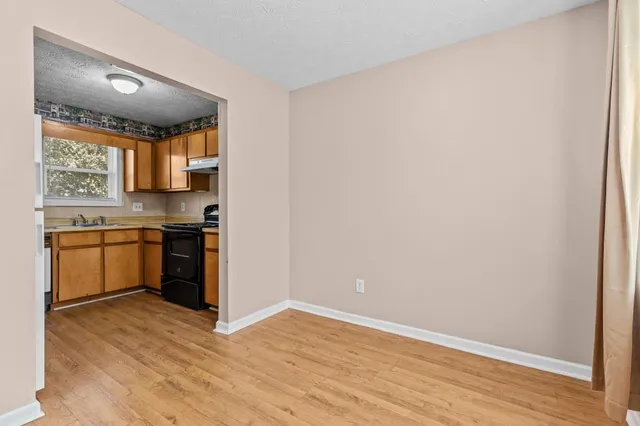 a view of a kitchen with a sink and cabinets