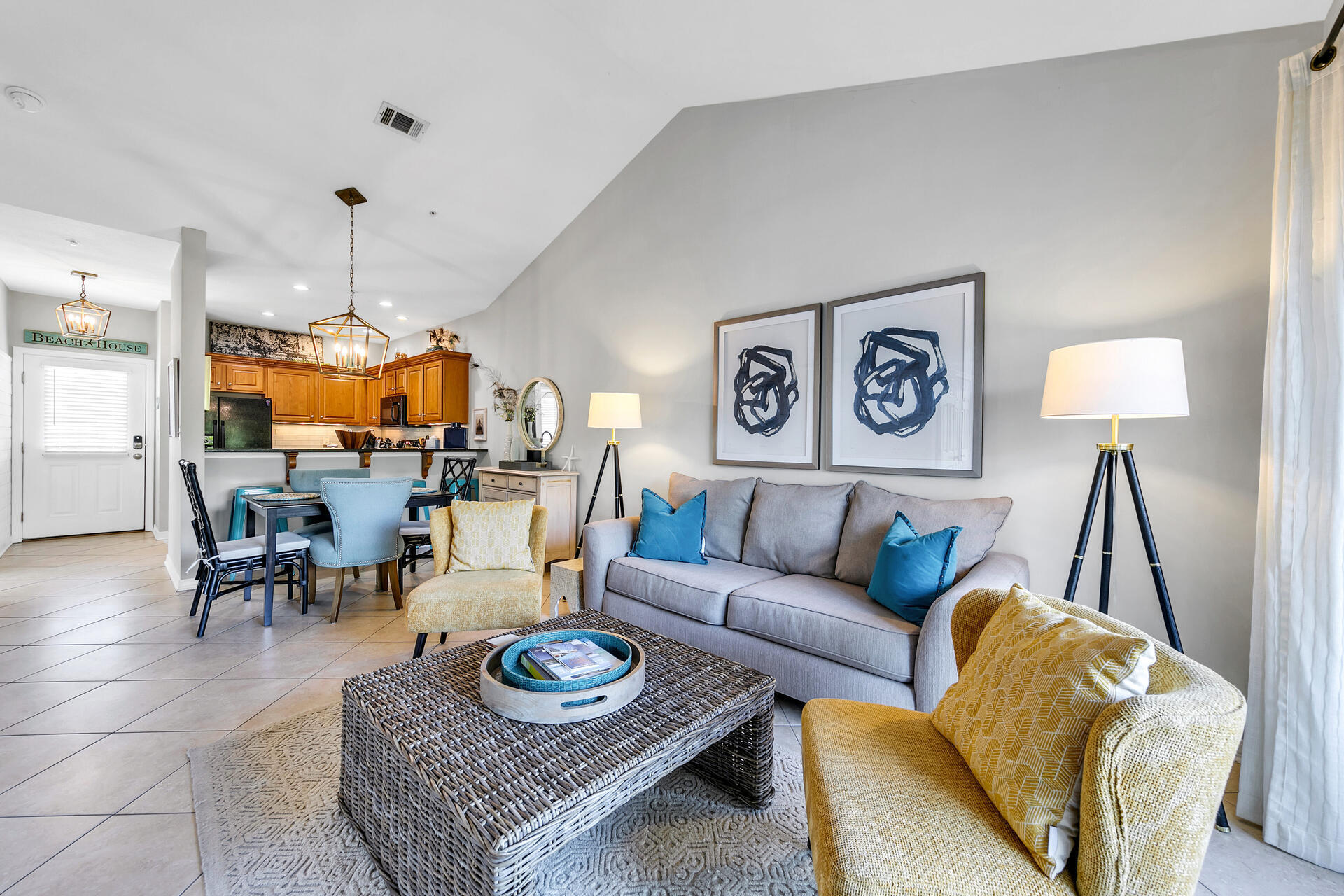 a living room with furniture kitchen view and a table
