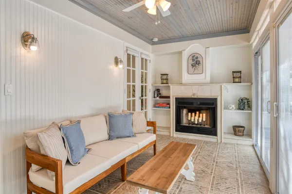 a living room with furniture and a ceiling fan