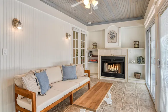 a living room with furniture and a ceiling fan