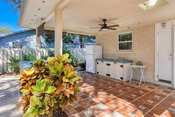 a view of a chairs and tables in the back yard of the house