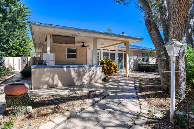 a view of a house with backyard and sitting area