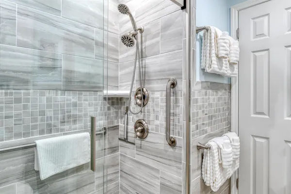 a bedroom with a bed and a flat tv screen on dresser