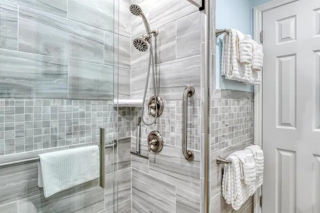 a bedroom with a bed and a flat tv screen on dresser