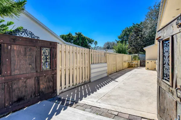 a view of a house with wooden fence