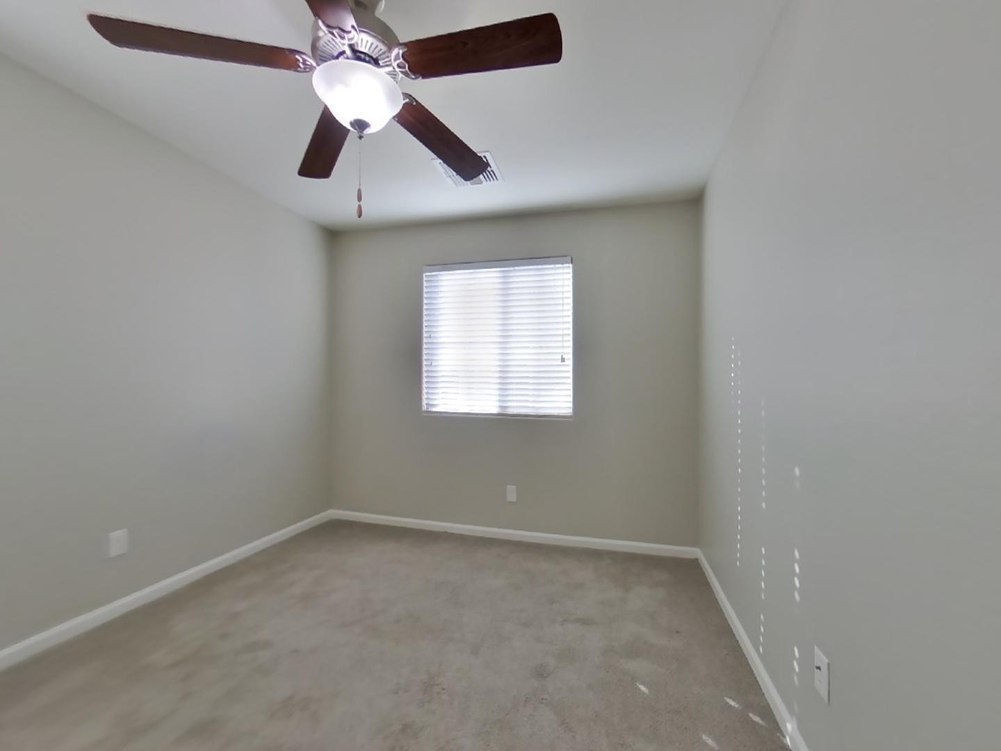 12565 West Via Dona Road Peoria, AZ 85383 - Photo 11 of 17 an empty room with a window and a fan