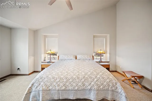 a bedroom with a bed and closet with mirror