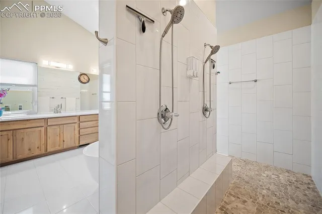 a bathroom with a shower sink and mirror