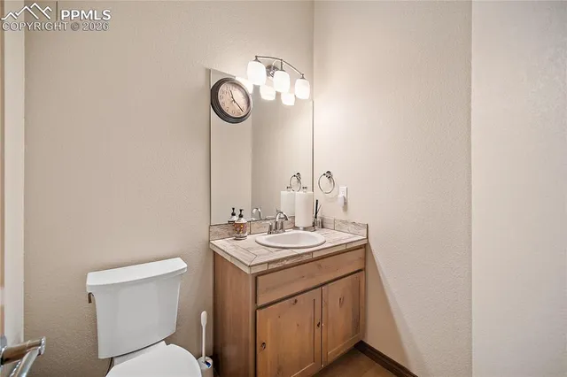 a bathroom with a toilet a sink and a mirror