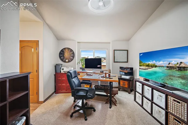 a view of a workspace with a table and a chair