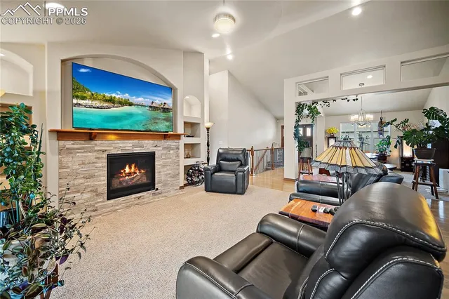 a living room with furniture fireplace and flat screen tv