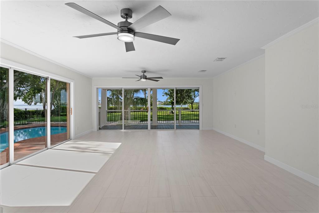 234 Driftwood Road Southeast St. Petersburg, FL 33705 - Photo 23 of 66 a view of an empty room with windows and chandelier fan