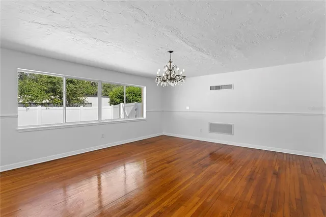a view of a porch with wooden floor and fence
