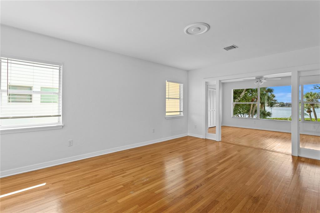 234 Driftwood Road Southeast St. Petersburg, FL 33705 - Photo 41 of 66 a view of an empty room with wooden floor and a window
