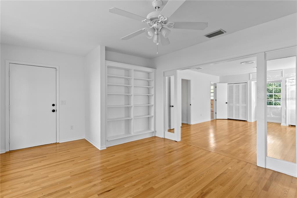 234 Driftwood Road Southeast St. Petersburg, FL 33705 - Photo 42 of 66 a view of empty room with wooden floor and fan