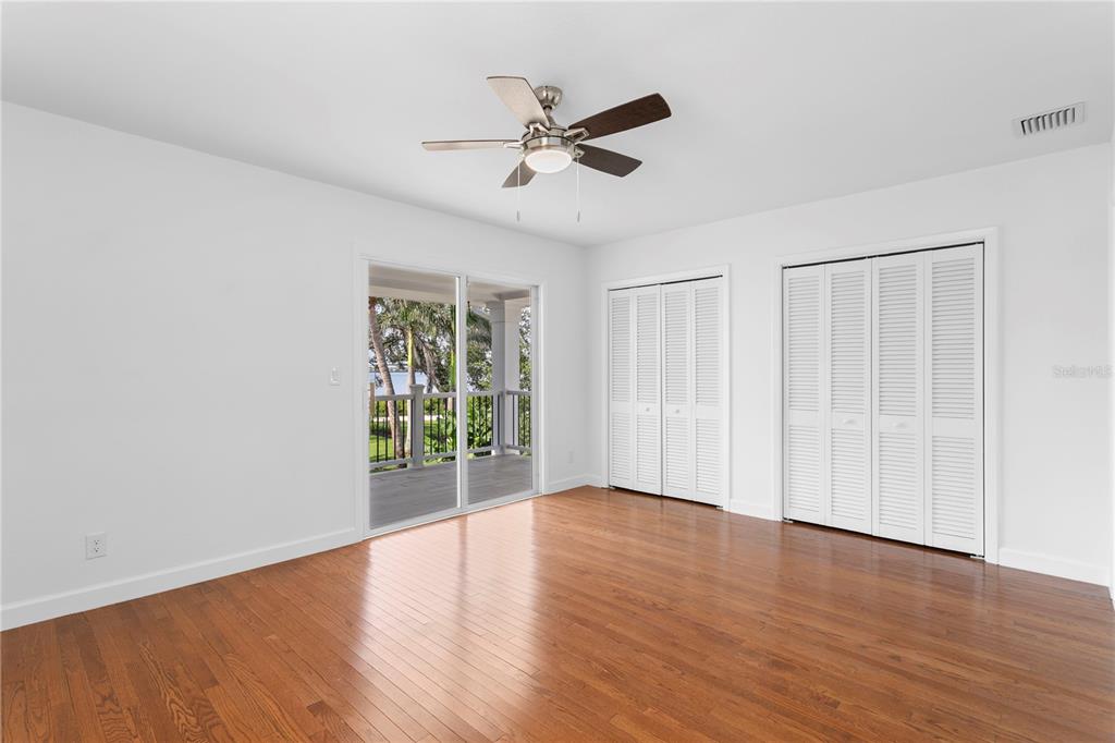 234 Driftwood Road Southeast St. Petersburg, FL 33705 - Photo 43 of 66 an empty room with wooden floor fan and windows